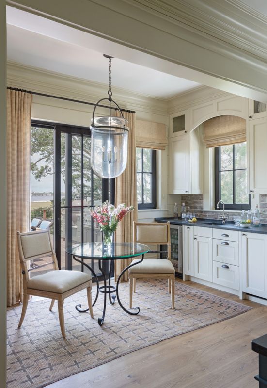 A petite sitting area in the kitchen, dominated by a daring pendant light from Urban Electric, provides the perfect spot for cocktails or coffee.