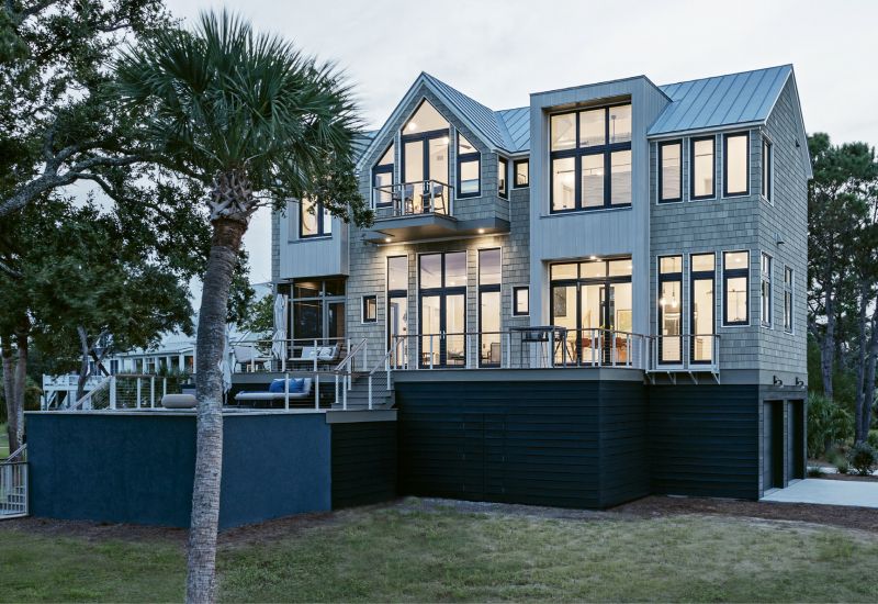 NATURAL CONNECTION: Steve and Heidi Newman chose a large marshfront lot on Edisto Island with proximity to the ocean for their new home, a property that would provide plenty of opportunity for viewing the abundance of birds. “The design concept was to always feel connected to the environment even if we had to be inside for whatever reason,” says Heidi. A plethora of picture windows allows for expansive views from every room, while a variety of outdoor living spaces invite the residents to soak up the scenery. A new dock gives them easy access to the marsh and nearby beach.