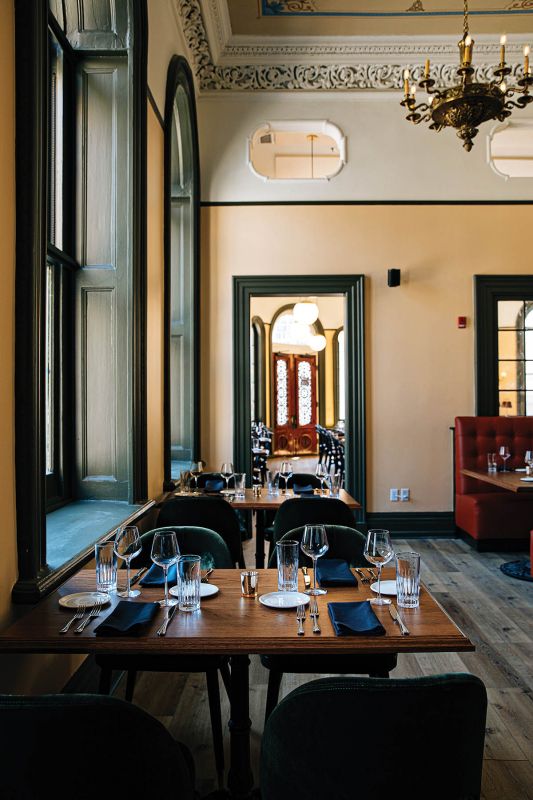 Brasserie La Banque’s airy dining room features original architectural details, such as the plaster cornice and frieze.