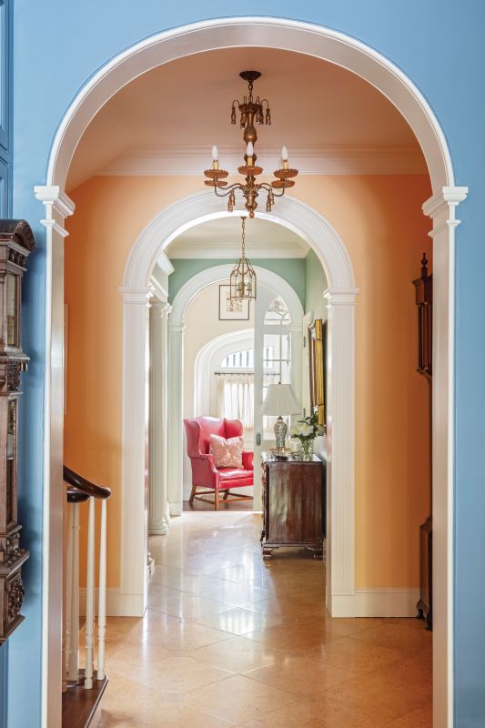 PAINT BY NUMBERS:  Interior designer Patrick Killian embraced Katy’s love of color by gracing every room with its own distinct hue. From “Old Blue Jeans” in the kitchen to “Pineapple Orange” in the stair hall to “Breakfast Room Green” in the garden room (all Benjamin Moore), the colors were calibrated to keep balance through the three distinct areas. Killian mixed the couple’s collection of antiques with local finds such as an 18th-century George Hepplewhite settee, adding a touch of whimsy with a crane mural by local artist Robert Shelton.