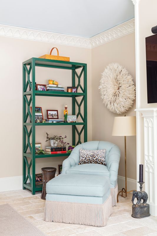 A tub chair and ottoman in a pale blue Cowtan & Tout fabric and...