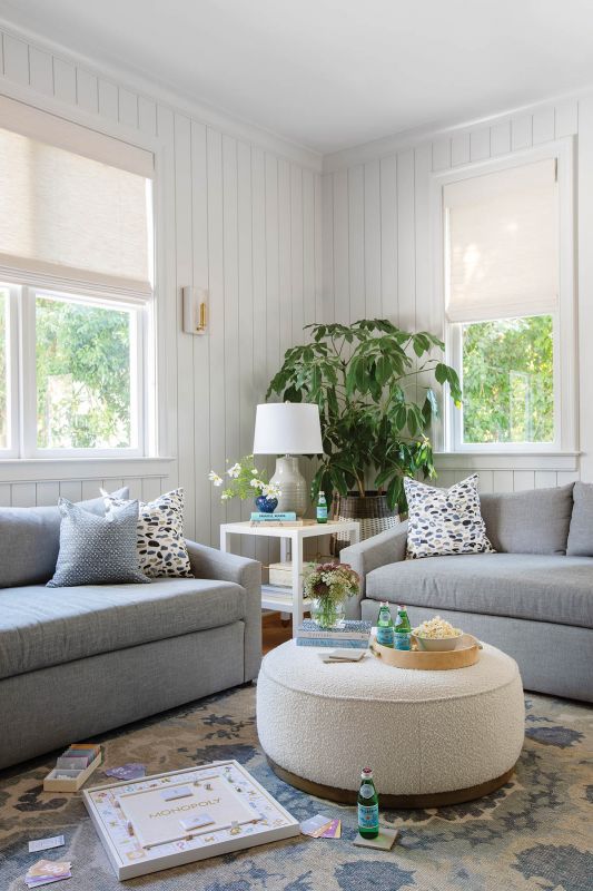 In the family room, Jesse Morgan sofas in gray Schumacher Crypton fabric sit atop a Turkish carpet.