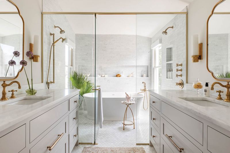 The spa-like, Carrara marble-clad en-suite bath features a wet room and brass fittings.