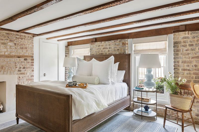 The windows in the suite’s cozy, first-floor bedroom were restored to match the upper windows on the home’s facade, with the added benefit of bringing in more light.