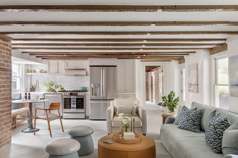 Once a separate apartment, the in-law suite features original brick and centuries-old, hand-hewn beams. Its main living area was the home’s original kitchen.