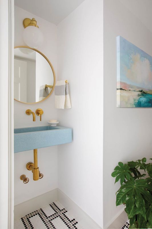The pool bath features penny-round diamond mosaic tile floors, a wall-mounted sink, and exposed brass plumbing.