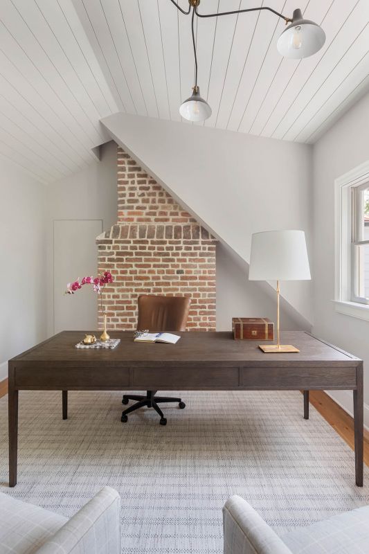 The rebuilt rear addition provided the Dions with spaces the house lacked, including an office for Tom outfitted with a Restoration Hardware desk and Visual Comfort chandelier.