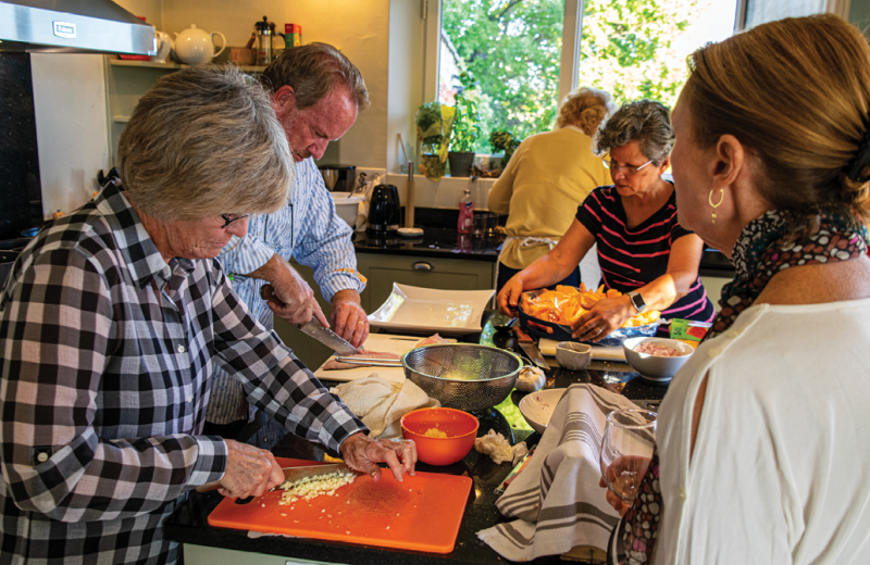 Working alongside Chef Bob to create the evening's gourmet meal