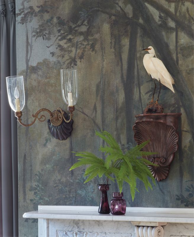 This hand-painted mural of a cypress swamp by artist Raymond Goins provided a unique starting point for a thoughtful re-imagining of an 18th-century single house’s dated interiors.