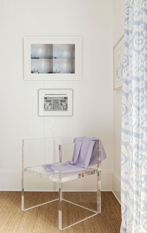 Art pieces and a modern acrylic chair from Interlude Home; the office entryway.