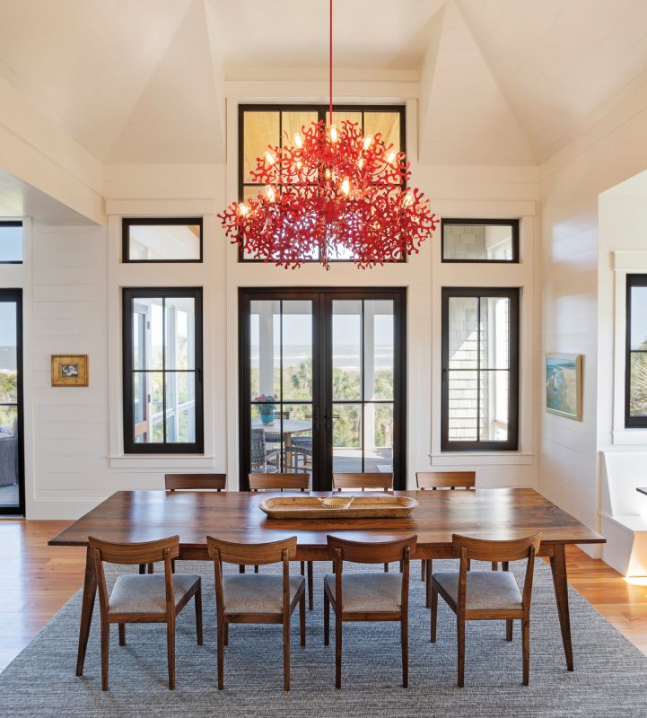 Of Earth & Sea: A striking red “coral” chandelier by Villa Tosca Design in Italy hangs above a handcrafted dining table by Landrum Tables of North Charleston. The juxtaposition is the centerpiece of the Beischel family house on Dewees Island, designed by architect Myles Trudell to be a multigenerational home that’s comfortable, casually elegant, and infused with a sense of whimsy.