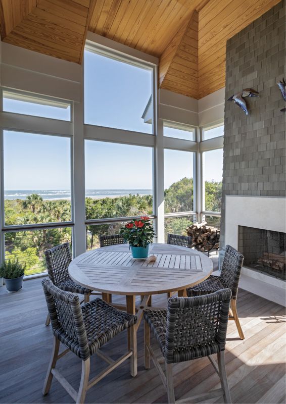 Among the Trees: The screened porch off the dining room is Toni’s favorite spot. Here, she likes to sip her morning coffee or retreat to read a book—which she can do in any season thanks to the fireplace. Every day, the couple ventures along the boardwalk to the beach, where they enjoy collecting shells and viewing the ample wildlife that call this maritime forest home.