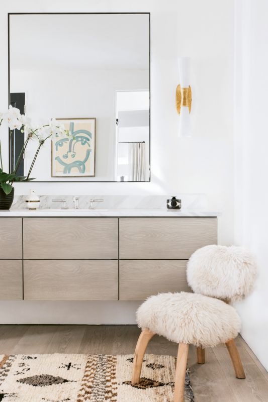 In the bath, floating custom cabinetry by Kris Kotlowski of Eurocraft Inc. echoes the cupboards in the kitchen.