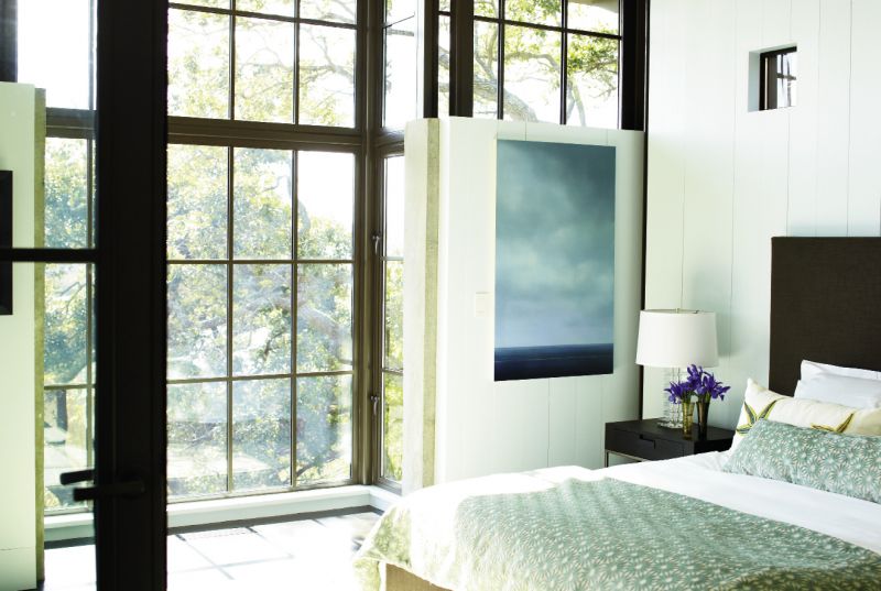 Dream State: Light from the marsh streams into the master bedroom, outfitted with a B&B Italia/Maxalto bed,  bedding from GDC, and a painting by Vermont artist Peter Brooke.