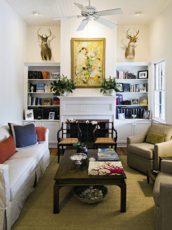 old meets new: With the help of interior stylist Nathalie Naylor, Jenny outfitted the living room with a sofa and pair of taupe chairs from Celadon, a coffee table recycled from the old house, and a pair of wooden armchairs re-covered in a fresh coral-patterned fabric.