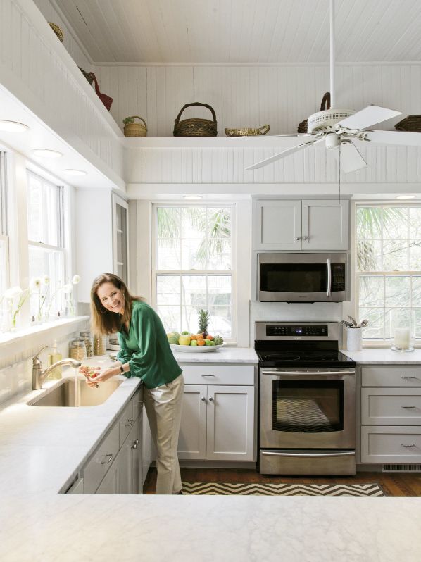 simple solutions:  Jenny gave the formerly yellow-gold walls in the kitchen a clean whitewash, replaced laminate countertops with sturdy Carrara marble, added white subway tiles, and updated the appliances.