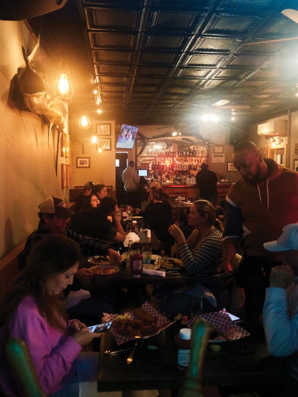 Dives & Taverns:A view from the Main Street sidewalk into Montauk’s Shagwong Tavern, open since 1927; during our visit, a handwritten sign in the window reads, “Piano player wanted, must have knowledge of opening clams.”