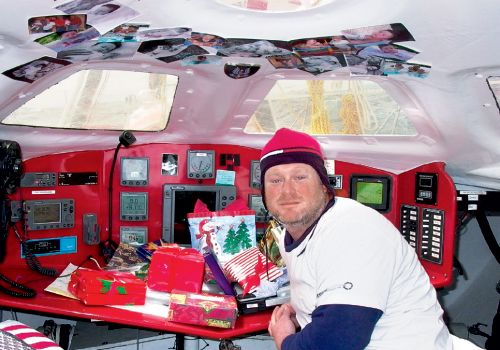 On Christmas Day, with only photos to keep him company, Brad opened a small pile of gifts, including books, DVDs, and a pint-sized African tree.