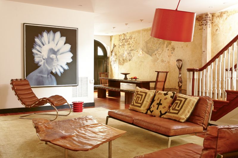 OUT OF AFRICA: Exotic textiles and a sculpture from Suzanne’s time in Africa lend a global bent to this dining and lounge space.